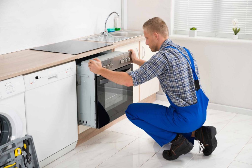 man installing oven