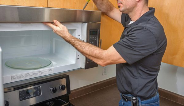 man installing microwave